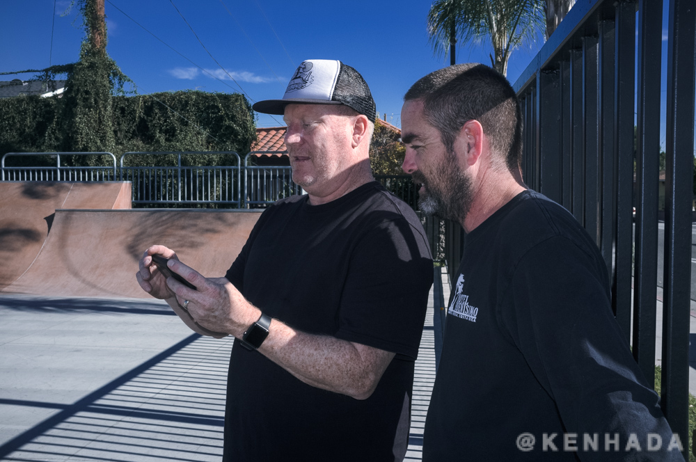 Eric and Jake looking over clips of their daughters skateboard session.